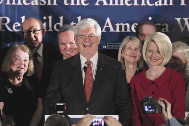 The former Speaker Newt Gingrich celebrates his win in South Carolina with his wife Callista, right