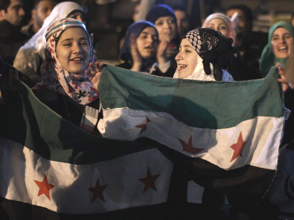 Syrian women protest outside the Arab League building yesterday in Cairo