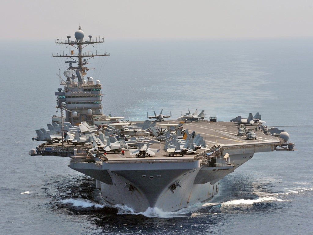 The USS Abraham Lincoln sailed through the Strait of Hormuz on Sunday and into the Gulf without incident, after Iran backed away from an earlier threat to take action if an American carrier returned to the strategic waterway