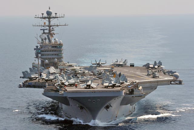 The USS Abraham Lincoln sailed through the Strait of Hormuz and into the Gulf without incident, after Iran backed away from an earlier threat to take action if an American carrier returned to the strategic waterway