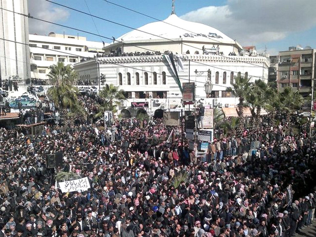 Outside Damascus, thousands mourned the deaths of 11 residents