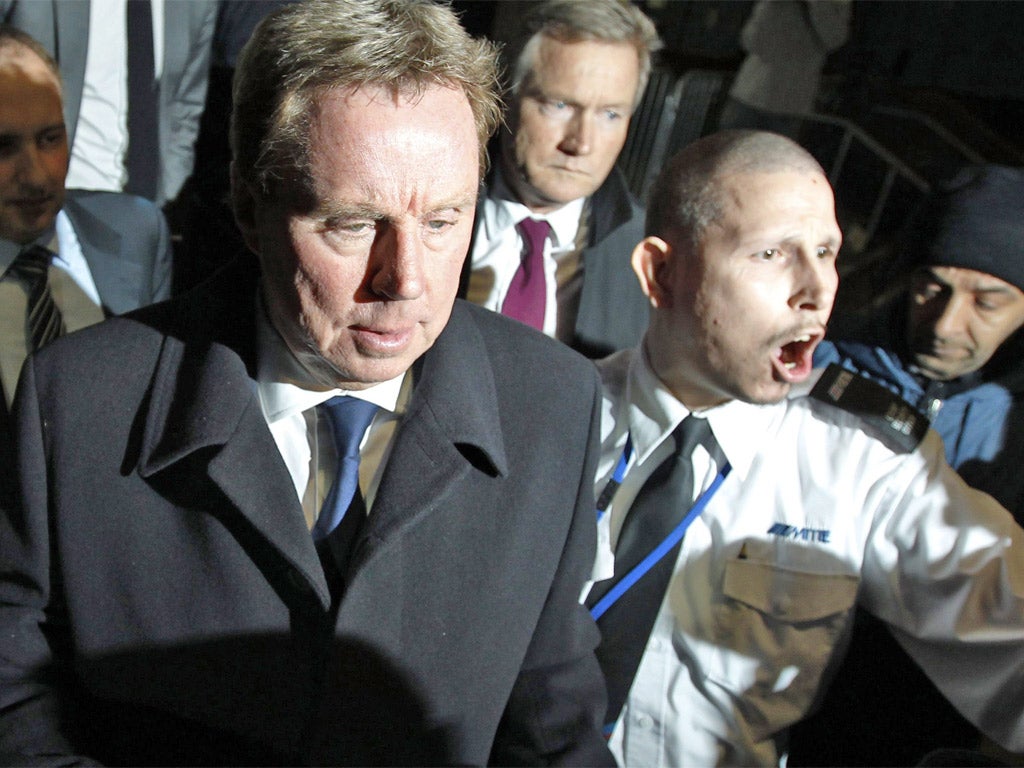A security guard clashes with the media as Spurs manager Harry Redknapp leaves Southwark Crown Court yesterday