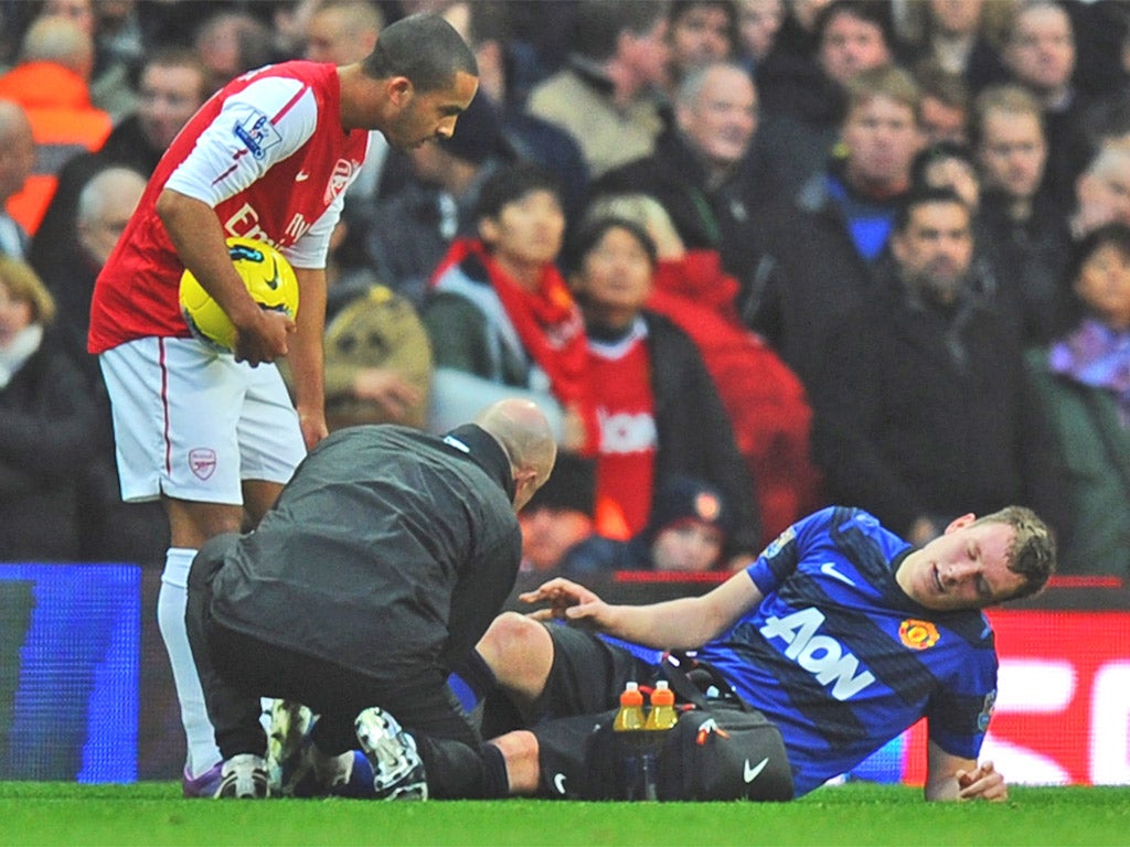 Phil Jones receives treatment during the victory at Arsenal