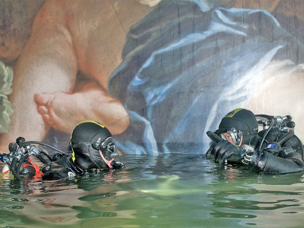 Italian Navy scuba divers inspect inside the Costa Concordia
