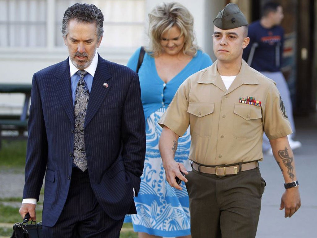 Marine Corps Staff Sgt. Frank D. Wuterich (right) arrives for a pre-trial hearing with his lawyer and girlfriend.