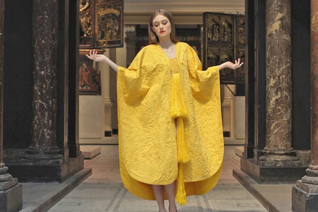 Model Bianca Gavrilas wears a a hand-embroidered cape made from the silk of the Golden Orb Spider in the V&A Museum's Medieval and Renaissance Gallery