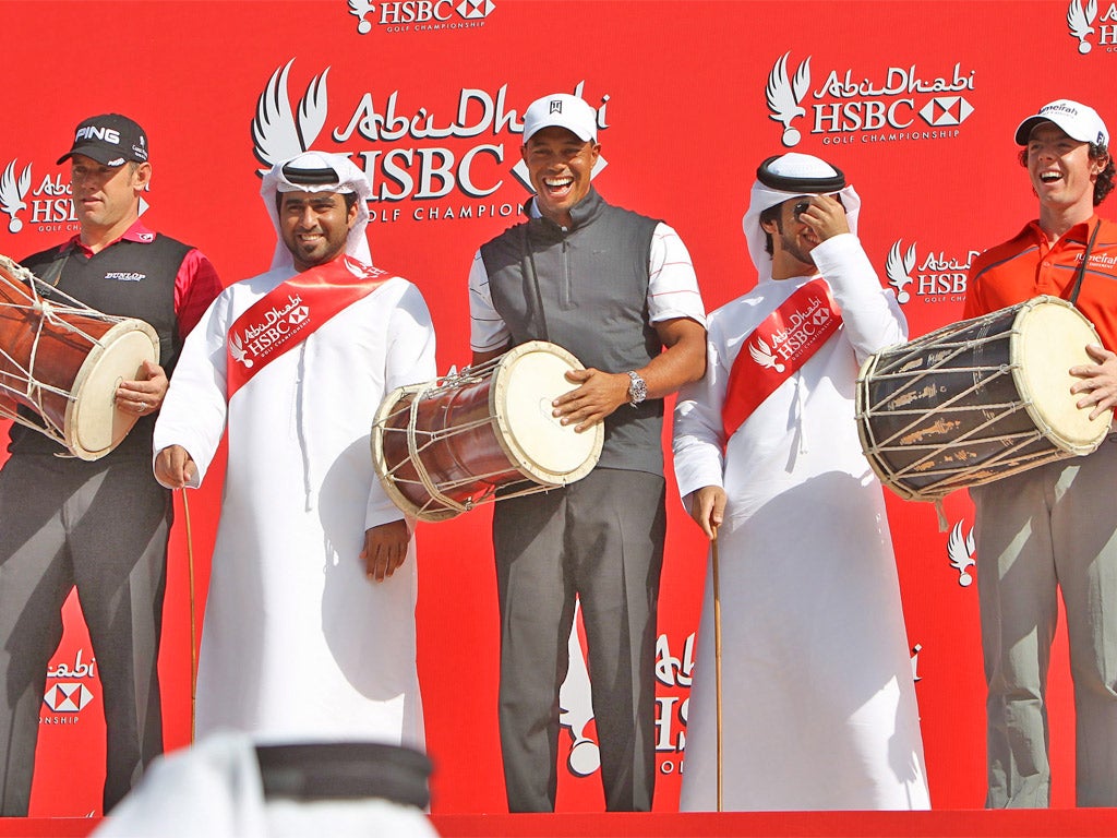 Lee Westwood, Tiger Woods and Rory McIlroy perform a traditional Emirati dance