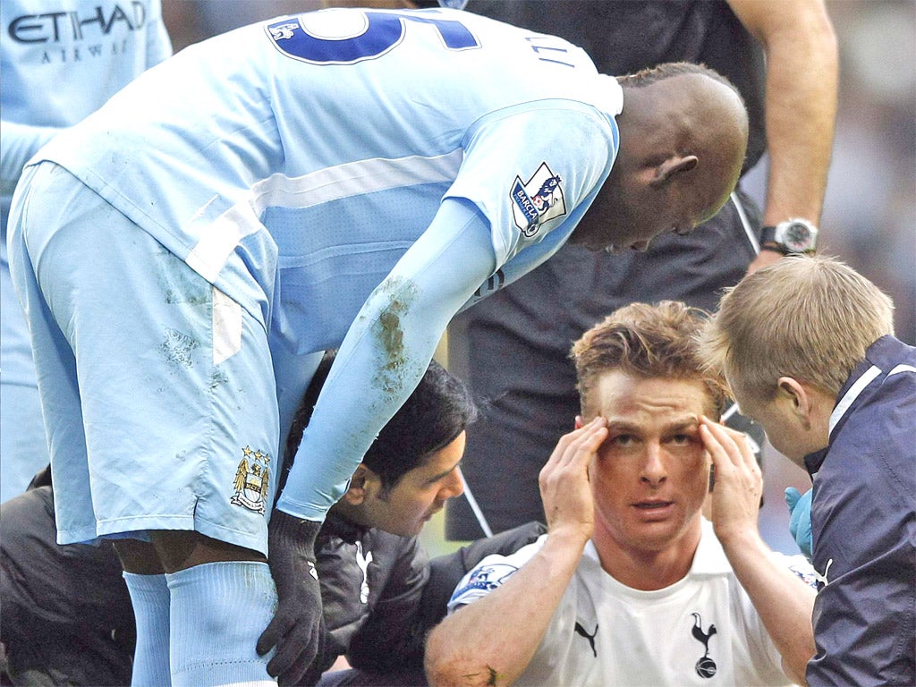 Mario Balotelli consoles Scott Parker after their collision on Sunday which the Italian striker insists was an accident