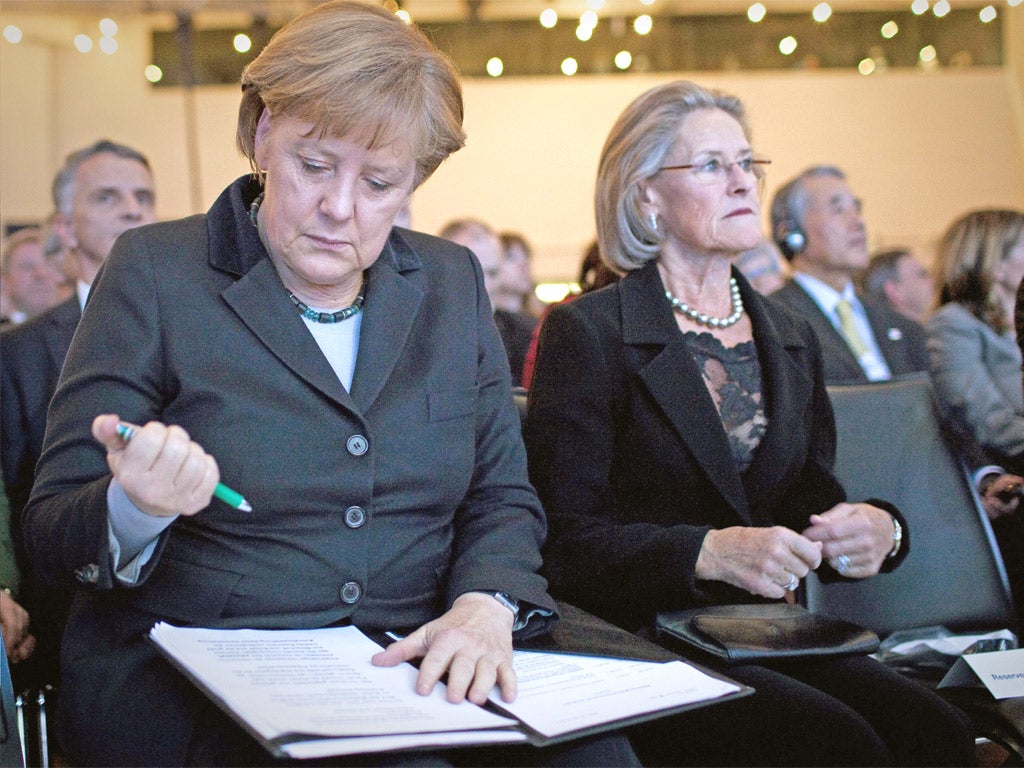 Angela Merkel works on her speech at Davos yesterday