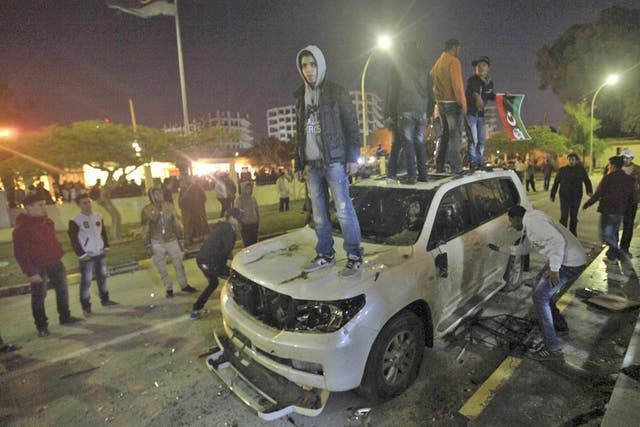 Libyans damage the car of National Transitional Council (NTC) chairman Mustafa Abdel Jalil, to express their dissatisfaction 
