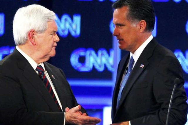 Former Speaker of the House Newt Gingrich (left) talks with Massachusetts Governor Mitt Romney during a break in the Republican presidential candidates debate in Florida 