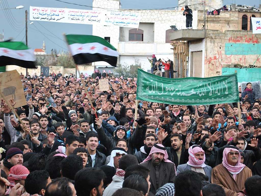 Anti-Syrian regime protesters demonstrate against Syrian President Bashar Assad in the Deir Baghlaba area in Homs province