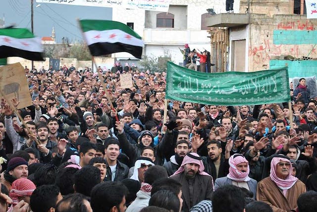 Anti-Syrian regime protesters demonstrate against Syrian President Bashar Assad in the Deir Baghlaba area in Homs province
