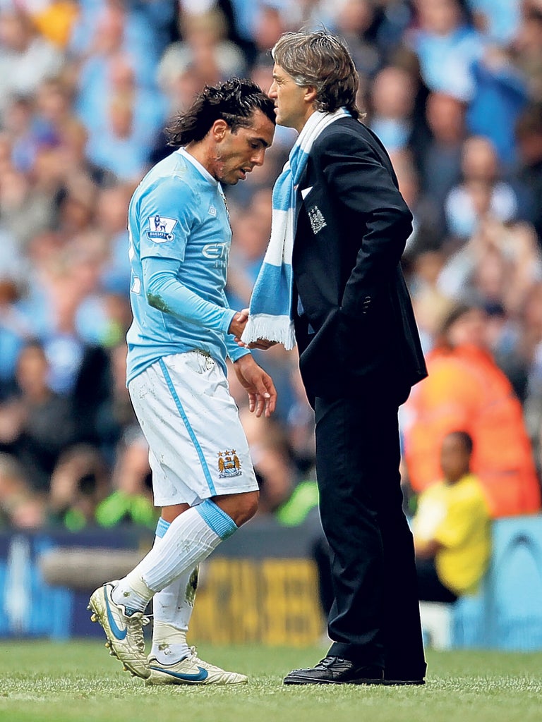 Carlos Tevez (left) and Roberto Mancini during happier times