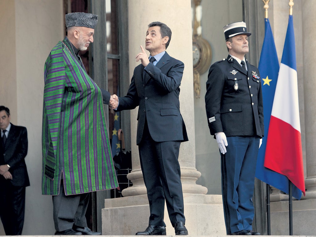 Hamid Karzai (left) and Nicolas Sarkozy meet in Paris yesterday
