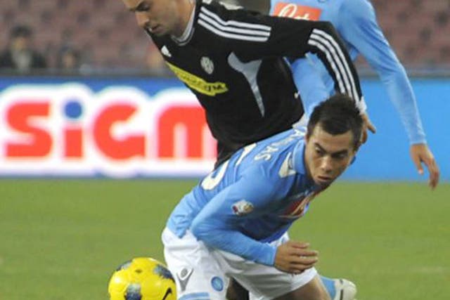 Napoli forward Eduardo Vargas of Chile, foreground, vies for the ball