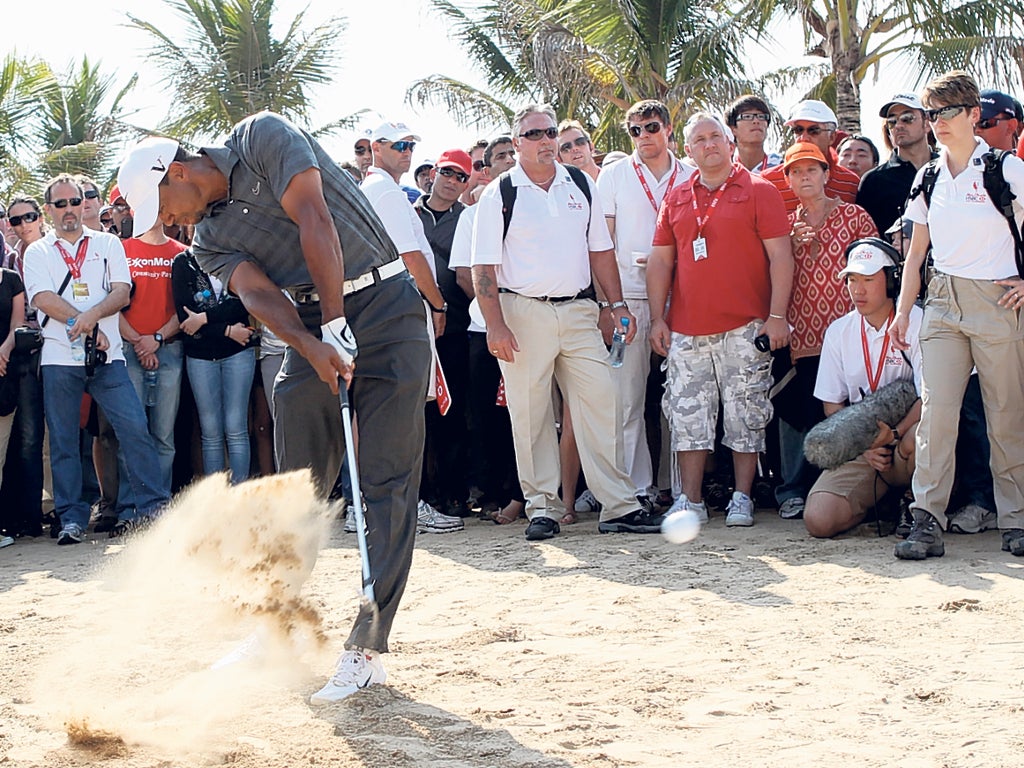 Swingtime: Tiger Woods on his way to a six-under-par 66 in the third round of the Abu Dhabi Championship yesterday