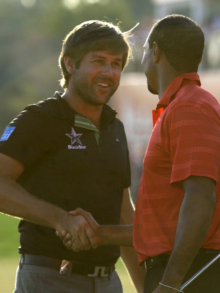 Tiger Woods congratulates England’s Robert Rock on his victory yesterday