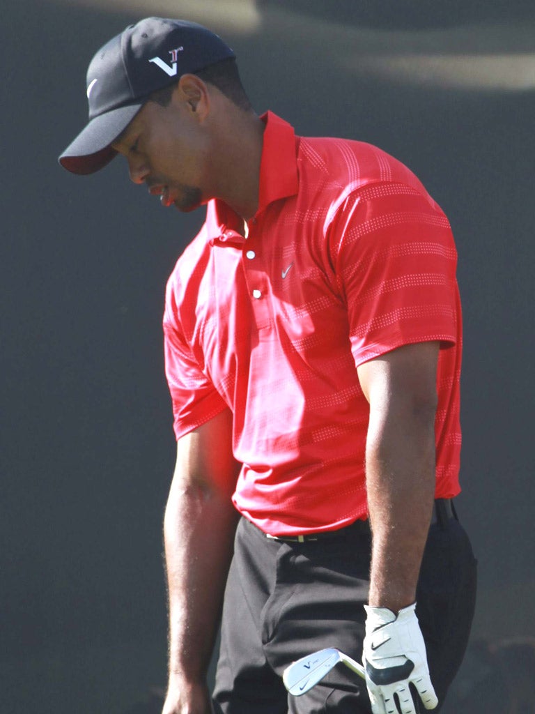 Tiger Woods, in Sunday red, fails to reel in Robert Rock yesterday