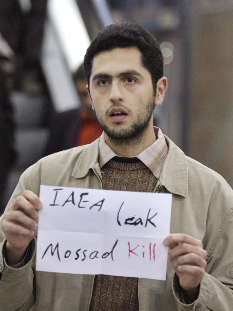 An Iranian protester confronts the nuclear inspectors yesterday