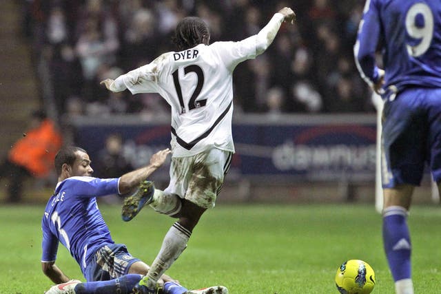 Chelsea's Ashley Cole brings down Nathan Dyer of Swansea to earn his second yellow card of the night at the Liberty Stadium 