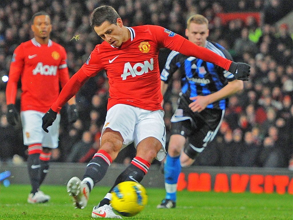 Javier Hernandez fires in the first of United's two penalties