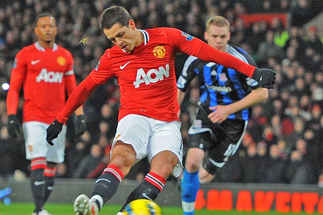 Javier Hernandez fires in the first of United's two penalties
