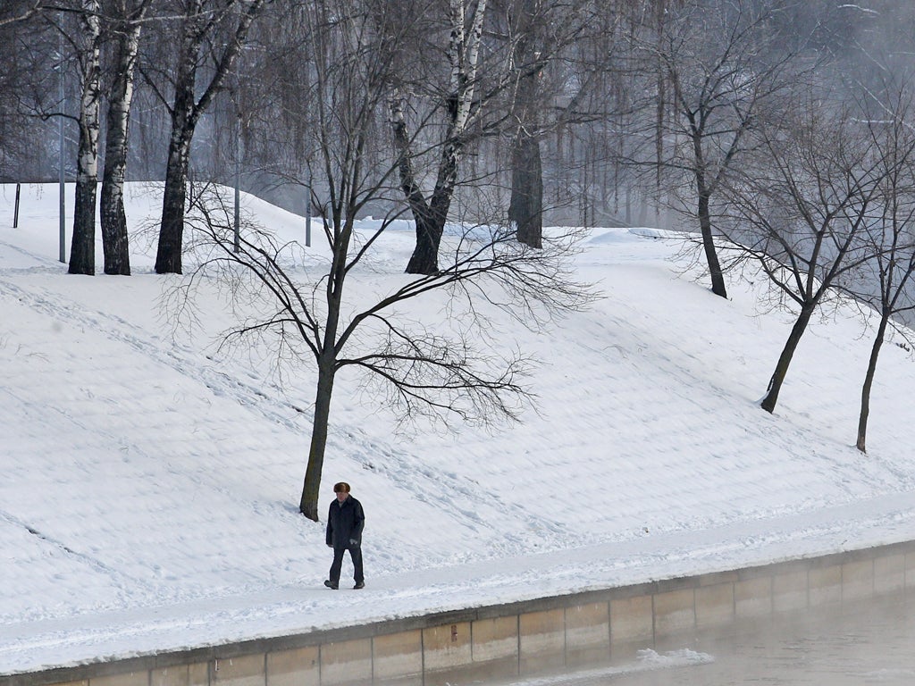 A man walks beside the Neris river in the Vilnius, Lithuania
