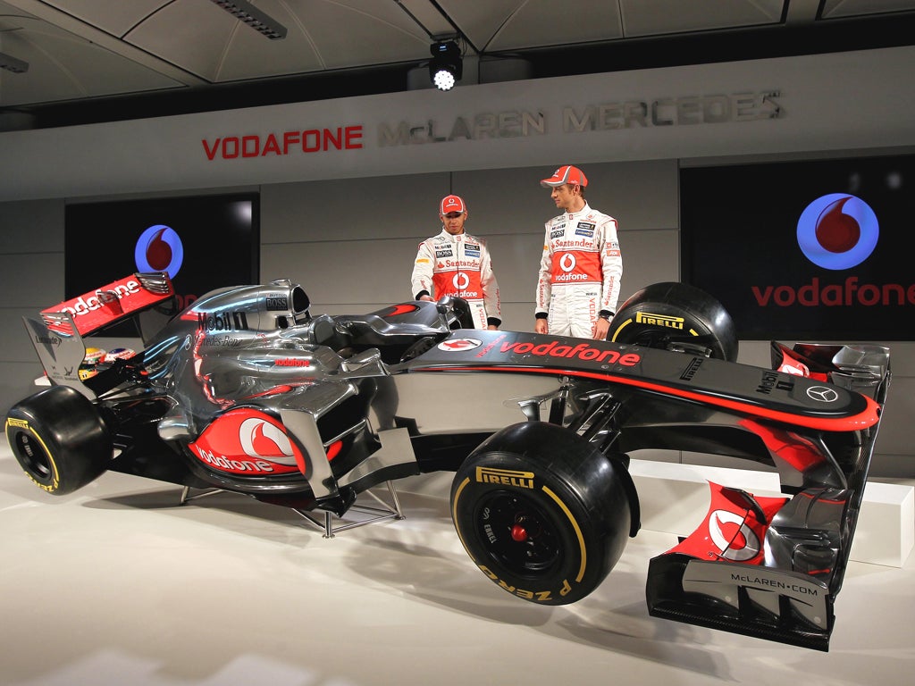 Lewis Hamilton and Jenson Button admire the new MP4-27 McLaren for the coming season
