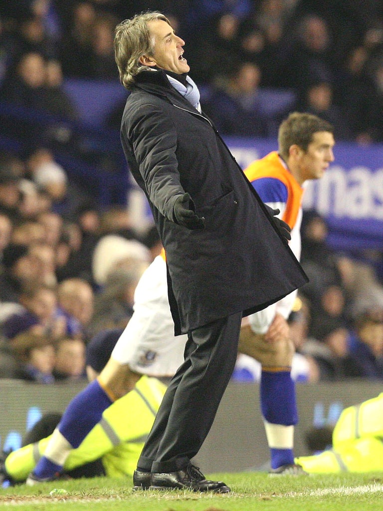 Mancini shows dejection during the match against Everton FC at Goodison Park