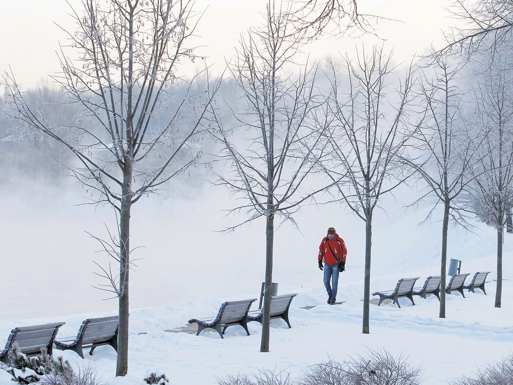 A man walks along the frozen River Neris in Vilnius,
Lithuania, yesterday as temperatures plummet to -30C