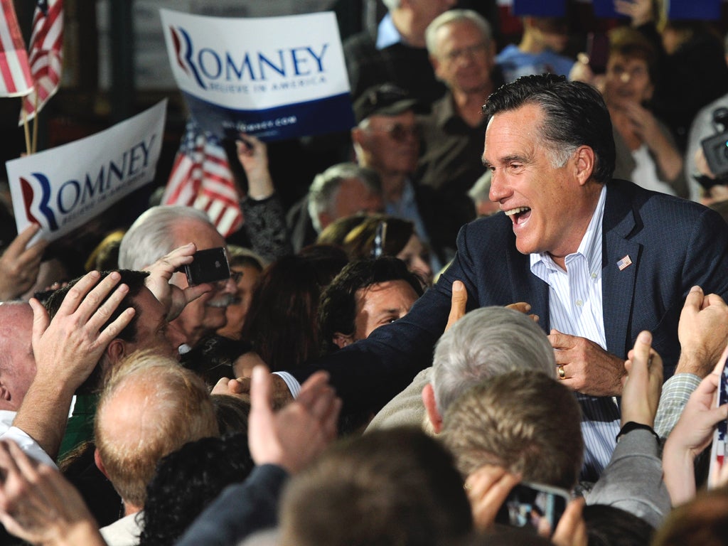 Mitt Romney greets supporters during a rally at Brady Industries in Las Vegas 