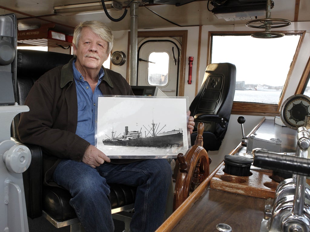 Greg Brooks holds up a photograph of the SS Port
Nicholson, which he says contains treasure