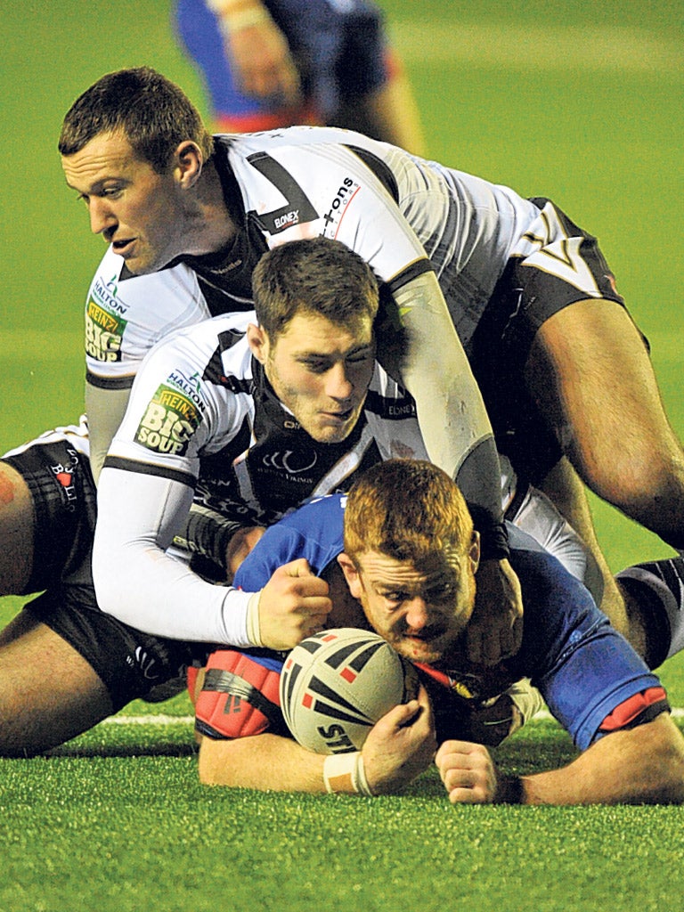 Wakefield’s Steve Southern is stopped by the Widnes defence last night