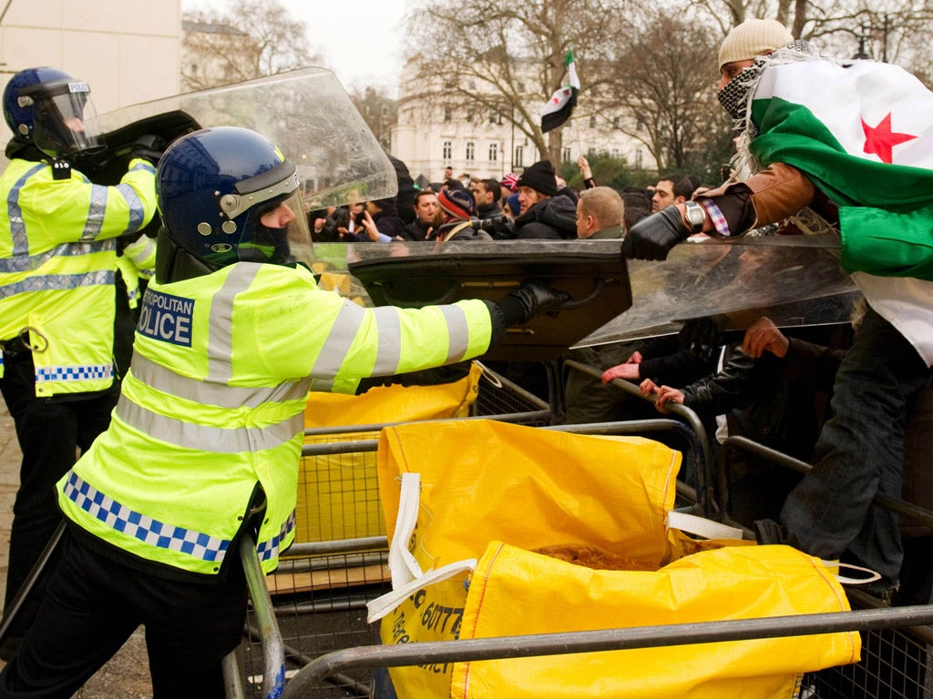 Protestors clash with police outside the Syrian embassy in central London