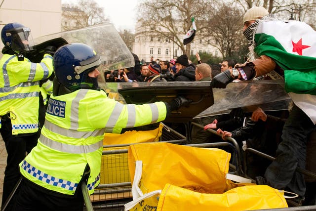Protestors clash with police outside the Syrian embassy in central London 