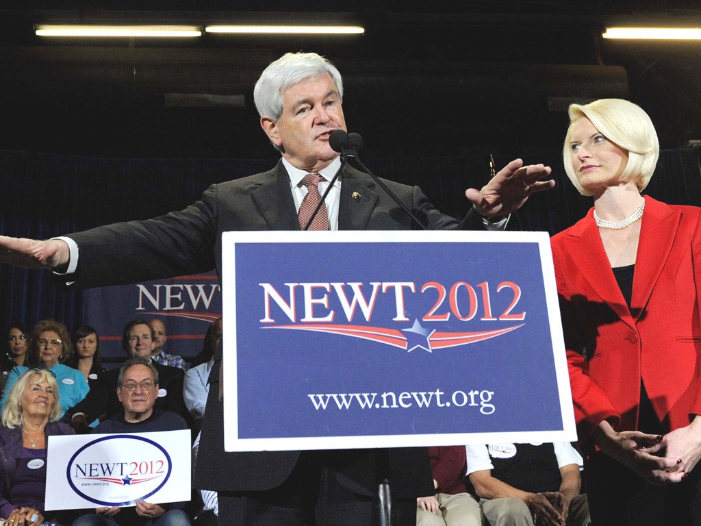 Newt Gingrich said he would continue his campaign and blamed Romney’s victory on his superior spending