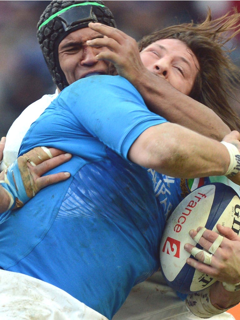 Italy prop Martin Castrogiovanni is tackled by Thierry Dusautoir