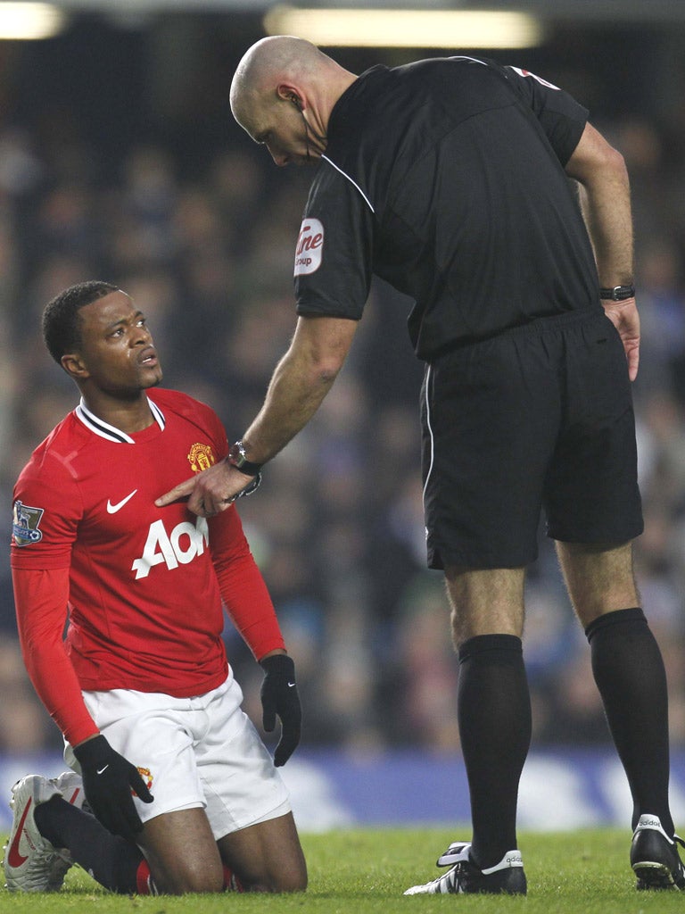 Howard Webb has a word with United’s Patrice Evra