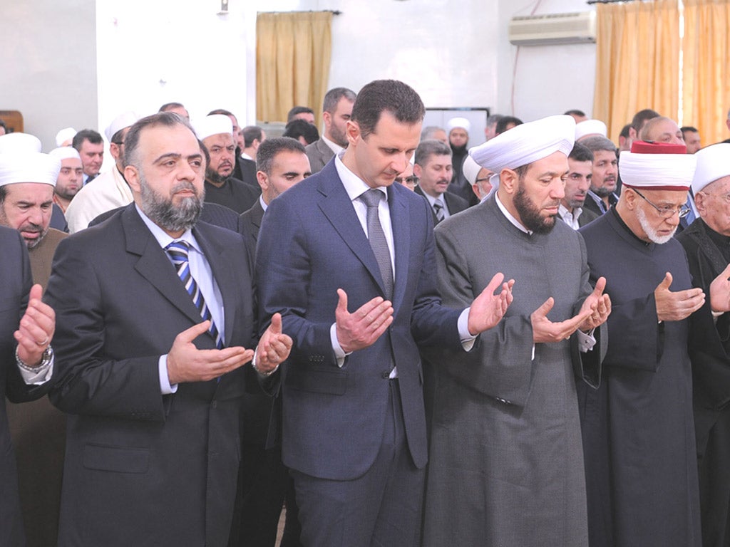 Syria’s President Bashar al-Assad prays during a celebration of Prophet Mohammed’s birthday at the al-Rawda mosque in Damascus yesterday