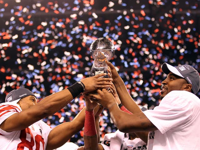 Victor Cruz (left) and Hakeem Nicks of the New York Giants pose with the Vince Lombardi Trophy after the Giants defeated the Patriots by 21-17