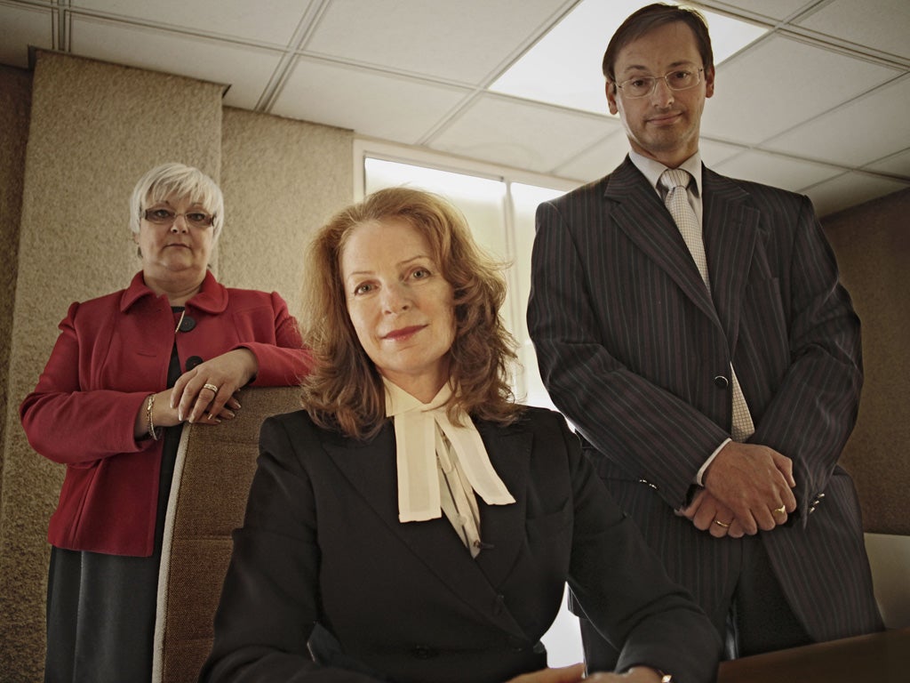 The death squad: Alison Thompson with her team at the coroner's office in West London