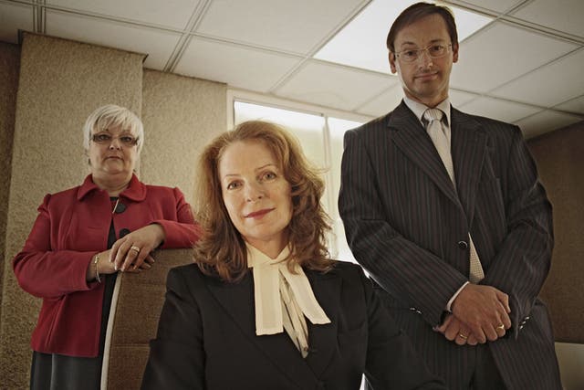 The death squad: Alison Thompson with her team at the coroner's office in West London