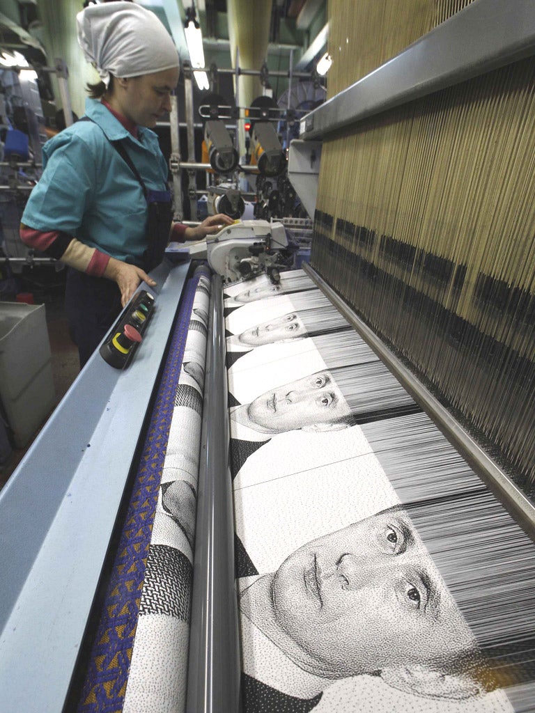 A weaver creates a tapestry of Vladimir Putin at a
factory near St Petersburg yesterday