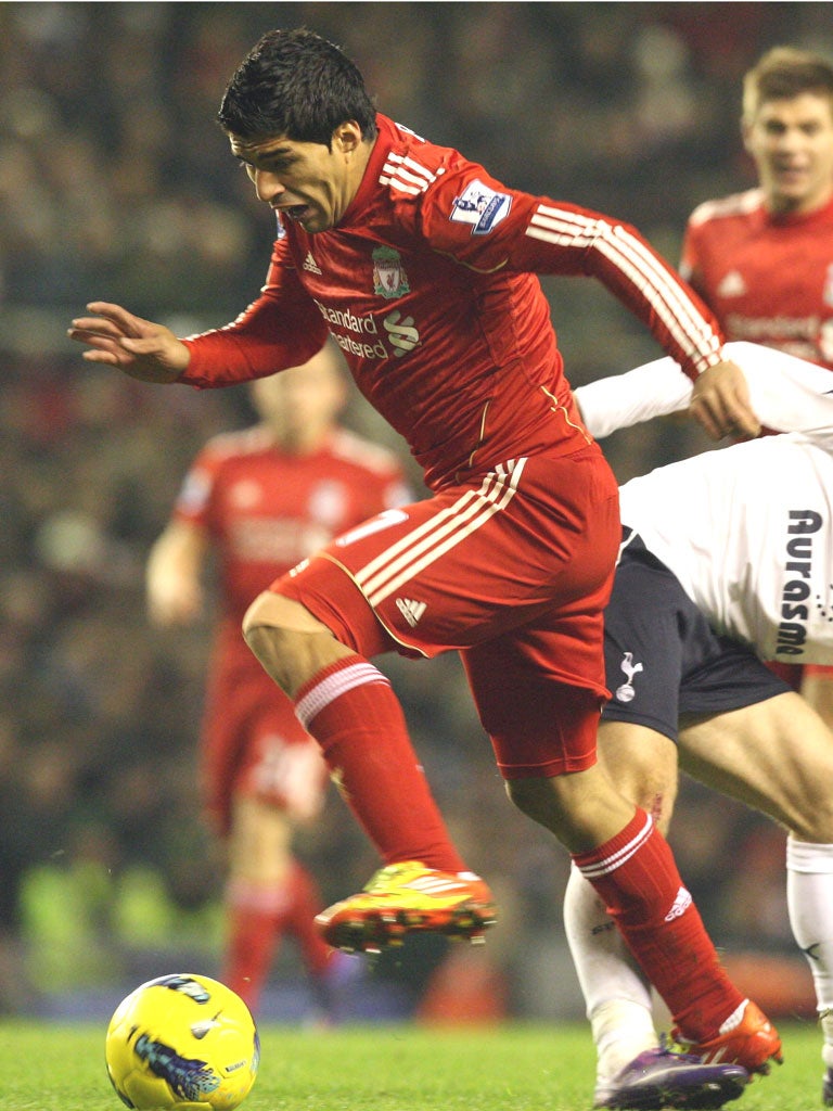 Liverpool’s Luis Suarez battles past Tottenham’s
Luka Modric in the goalless draw at Anfield last night