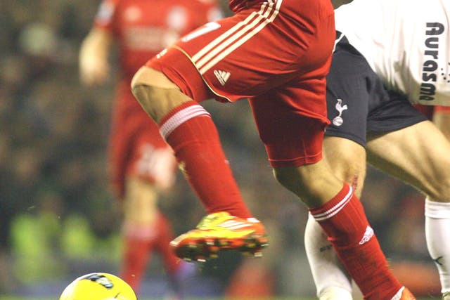 Liverpool’s Luis Suarez  battles past Tottenham’s
Luka Modric in the goalless draw at Anfield last night
