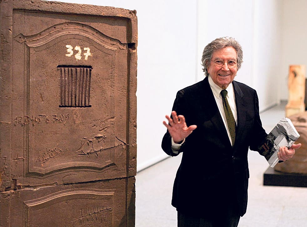 Tapies next to one of his pieces during an exhibition of his work in Madrid in 2004 
