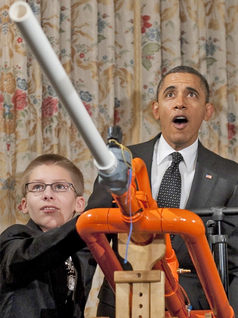 Barack Obama reacts after firing 14-year-old Joey Hudy's 'Extreme Marshmallow Cannon' during a science fair at the White House yesterday. The President announced new policies to recruit and support science teachers