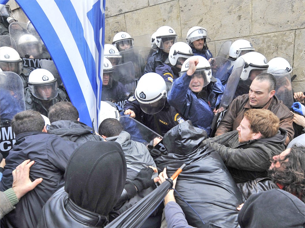 Protesters clash with riot police during the 24-hour general strike in Athens yesterday