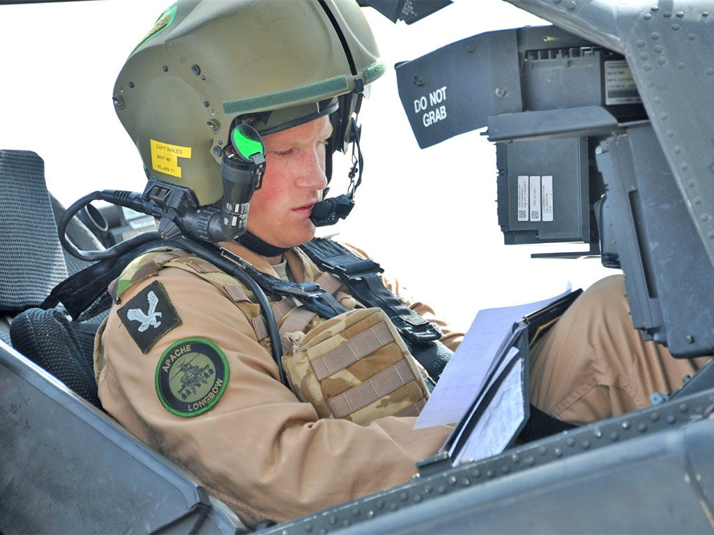 Prince Harry prepares for a training mission in an Apache helicopter
